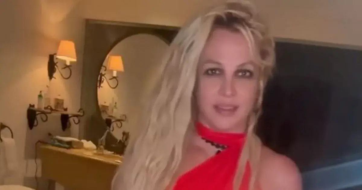 Britney Spears left followers concerned after she poses in a slinky red halter-neck dress and struts around