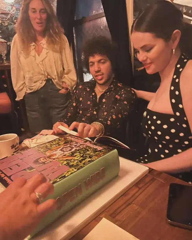 There was a cake shaped like his book with a photo of him and a green spine, and Selena impersonated eating it while posing for pictures.
