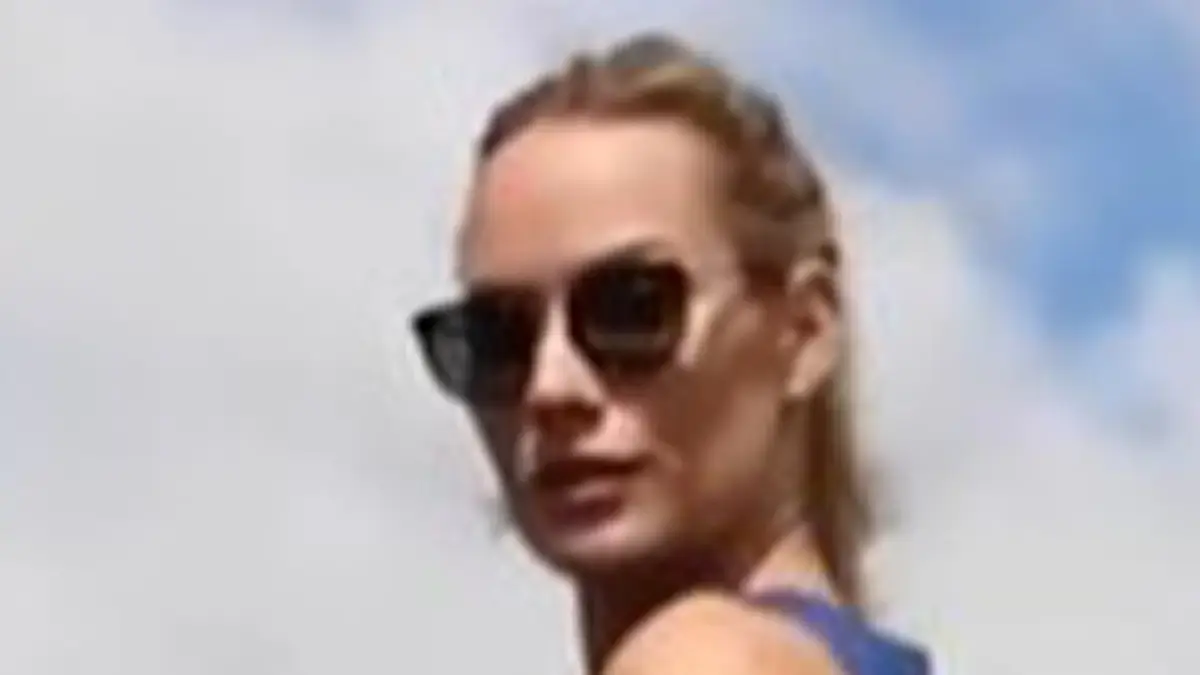 Paige Spiranac, 31, wore a short blue dress and almost suffers a wardrobe malfunction when her skirt almost rode up her leg