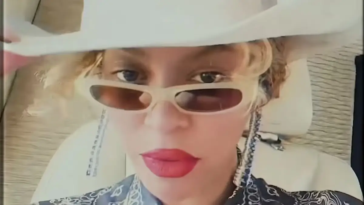 Beyonce continues to embrace her cowgirl as she wore a dark blue ensemble and added a tan cowgirl hat to her look