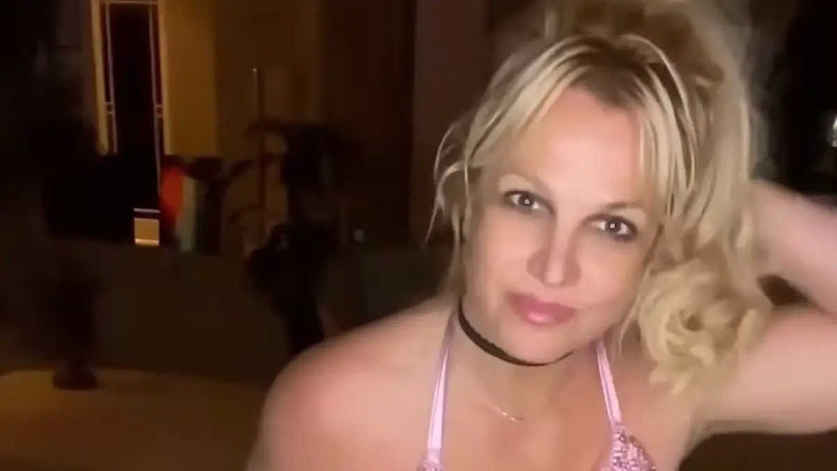 Britney Spears flaunted her figure in the latest dance video as she wore an extreme plunging glitzy pink dress