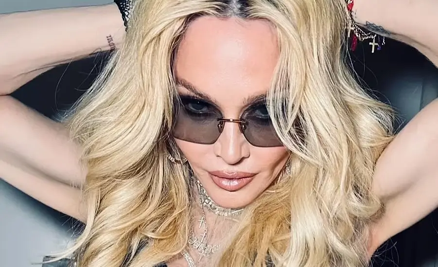 Madonna stunned in a black bustier and fishnets in risqué behind-the-scenes