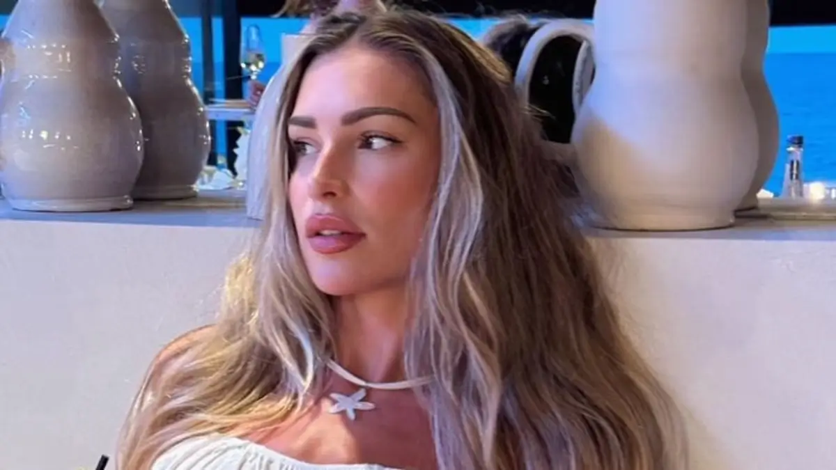 Zara McDermott shows off her jaw-dropping body by going braless in a white cropped top and matching maxi skirt