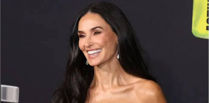 In a figure-hugging, strapless black-and-red dress, Demi Moore looks years younger than her age at the LA premiere of The Substance