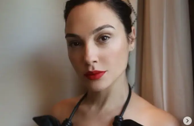 Gal Gadot looked stunning in a braless leather dress that fell just above the ankles and showcased her toned arms and shoulders