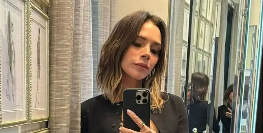 Victoria Beckham, 50, looked stylish as ever in a low-cut black dress with a white trim and a cropped black cardigan as she shops in LA