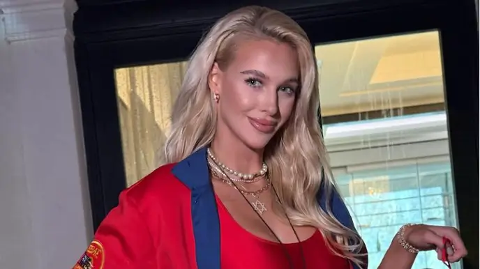 A plunging neckline provides a glimpse of Veronika Rajek’s ample assets as she wears a red swimsuit
