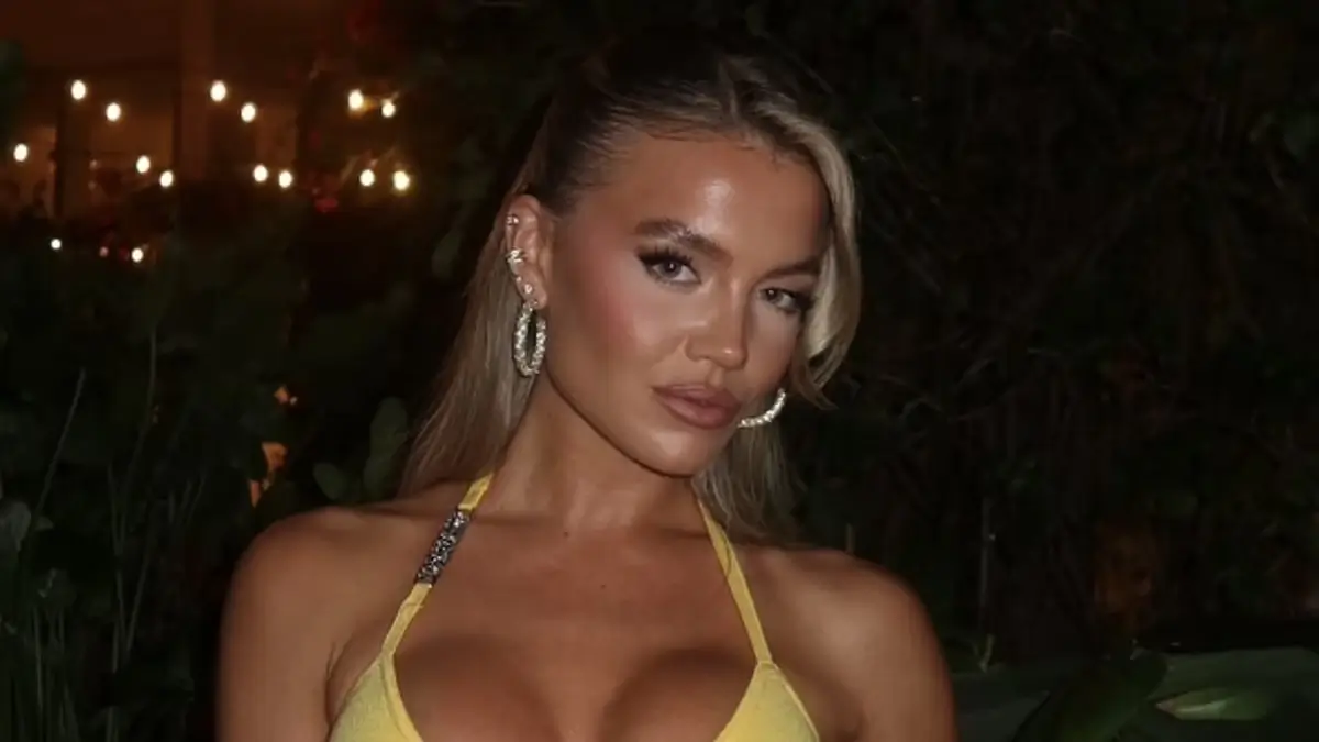 A tiny yellow unitard that Molly Smith wore clung to her killer curves in several of the scorching snaps