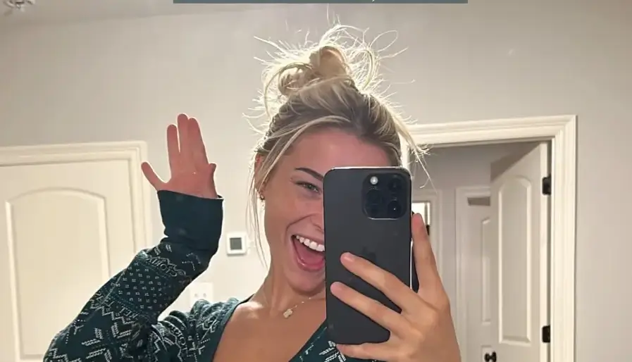 Olivia Dunne highlighted her toned body with a fitted pair of shorts and a long-sleeved top with a plunging neckline in a Christmas-themed post