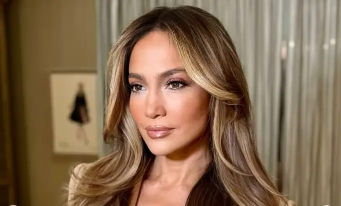 Jennifer Lopez flaunted her enviable figure in a black tiny string bikini with gold accents, showcasing her toned abs