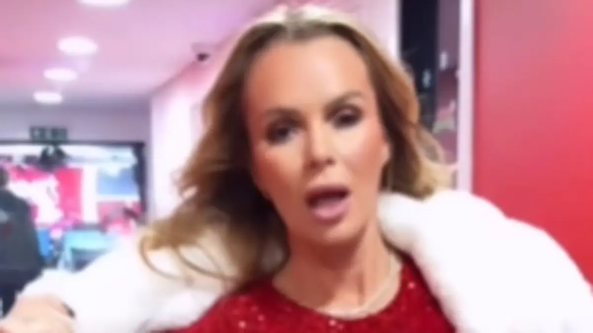 Amanda Holden sizzles in a stunning red sequin minidress and matching tights as she poses up a storm for a captivating new video
