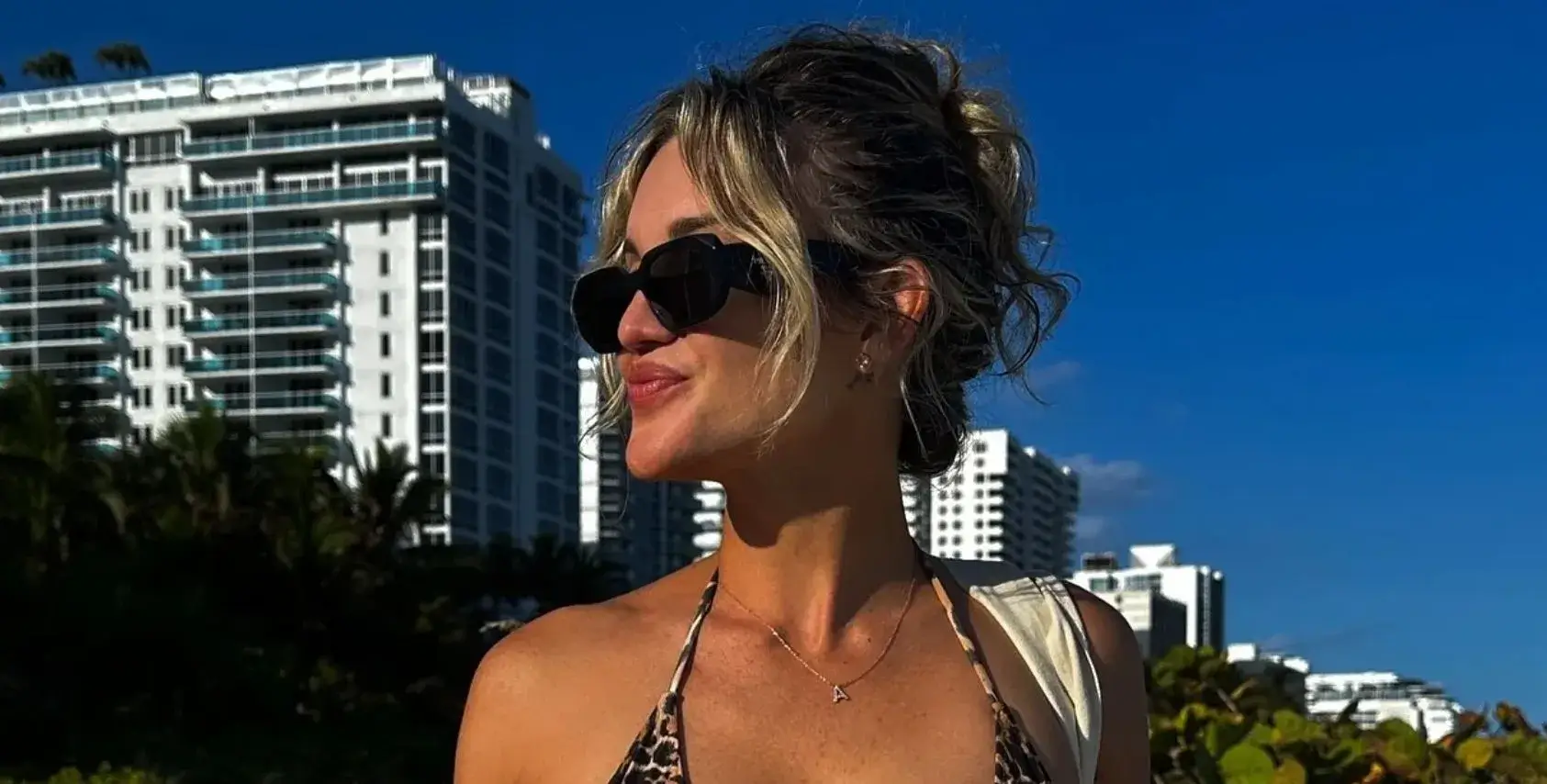 Ashley Roberts flaunted her abs and underboob while posing on the beach in a tiny leopard print bikini