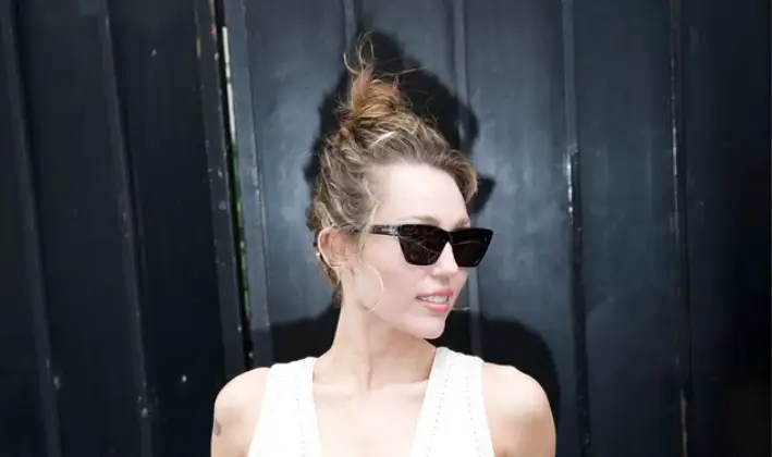 Miley Cyrus turns heads in a breathtaking cream dress featuring a daring thigh-high split and stunning rope detailing across her midriff