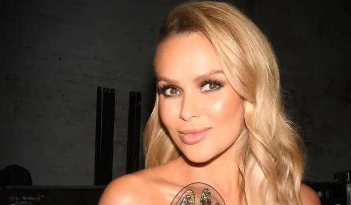 Amanda Holden wowed in a daring black bodysuit, adorned with a sheer, embroidered butterfly design that wrapped around