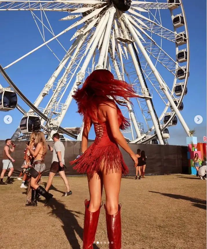 Her attire, a racy suede mini dress with a fringed skirt, accentuated her incredible figure. Paired with matching leather knee-high boots, the ensemble was a testament to her impeccable style.