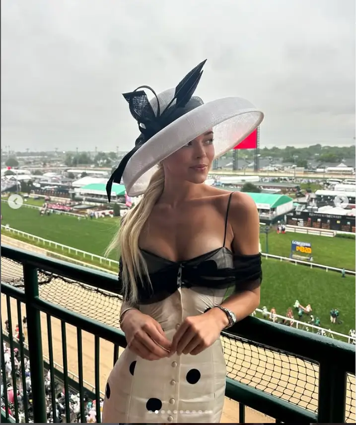 For this event, she chose a white dress adorned with black polka dots, which accentuated her curvaceous figure. The dress's design, with its thin straps, showcased her slender arms elegantly.
