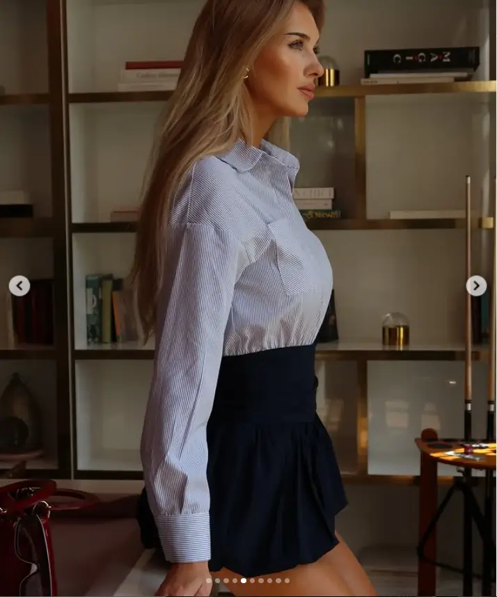 Donning a thigh-skimming miniskirt and a fitted shirt, Veronika's figure was accentuated by her choice of attire. Her height was further emphasized by the high heels she wore, creating a striking visual impact.