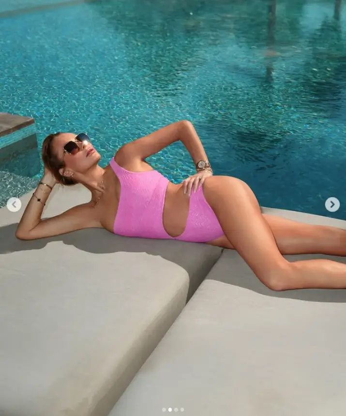 Amanda Holden unveiled her age-defying physique in a pink swimsuit on Sunday, captivating audiences with her stunning figure.
