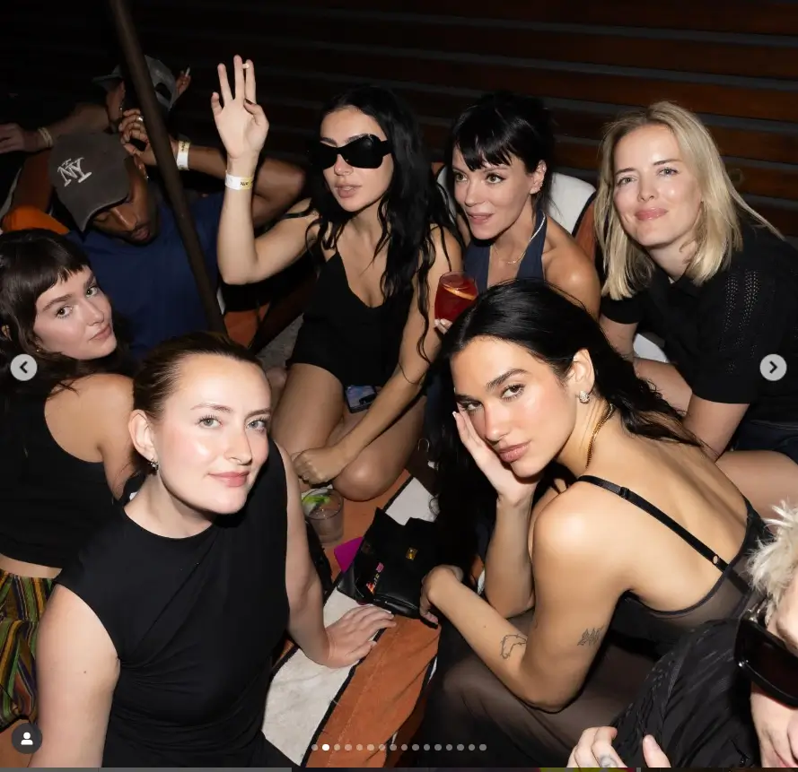 Dua Lipa exudes sensuality in a daring sheer dress, engaging in a provocative display with her fiancé, Callum Turner, amidst a night of revelry.