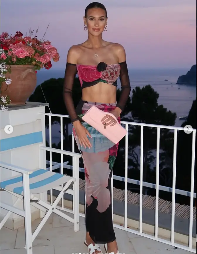 Donning a multi-tonal red, pink, and black ensemble, Veronika modeled a low-cut bandeau top with sheer black sleeves. This outfit, partnered with Fashion Nova, maintained a level of classiness despite the risk of a wardrobe malfunction.