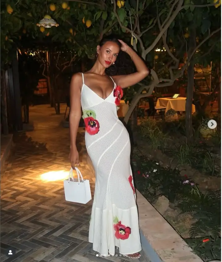 She turned heads in a breathtaking Bottega Veneta dress! The fitted plunging design beautifully accentuates her amazing figure, while the intricate red floral appliqués add a touch of elegance.
