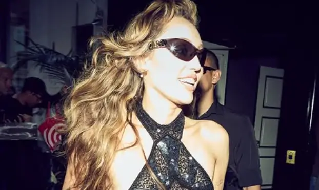 Miley Cyrus flashes her sideboob in tiny halter top complemented by belted cutoff denim shorts, fishnet stockings Miley Cyrus flashes her sideboob in tiny halter top complemented by belted cutoff denim shorts, fishnet stockings