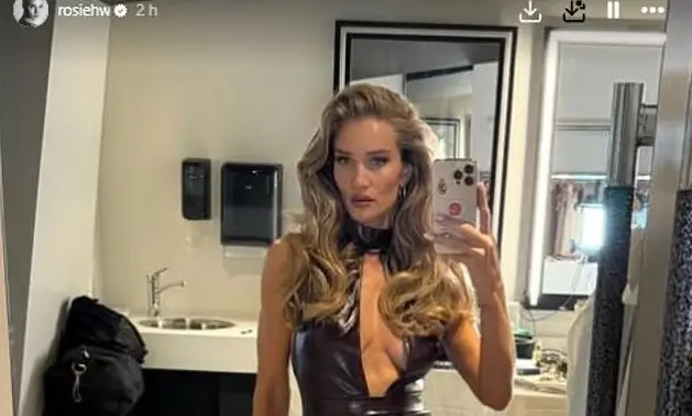 Rosie Huntington-Whiteley exuded sensuality in a daring ensemble with a plunging neckline and a thigh-high split