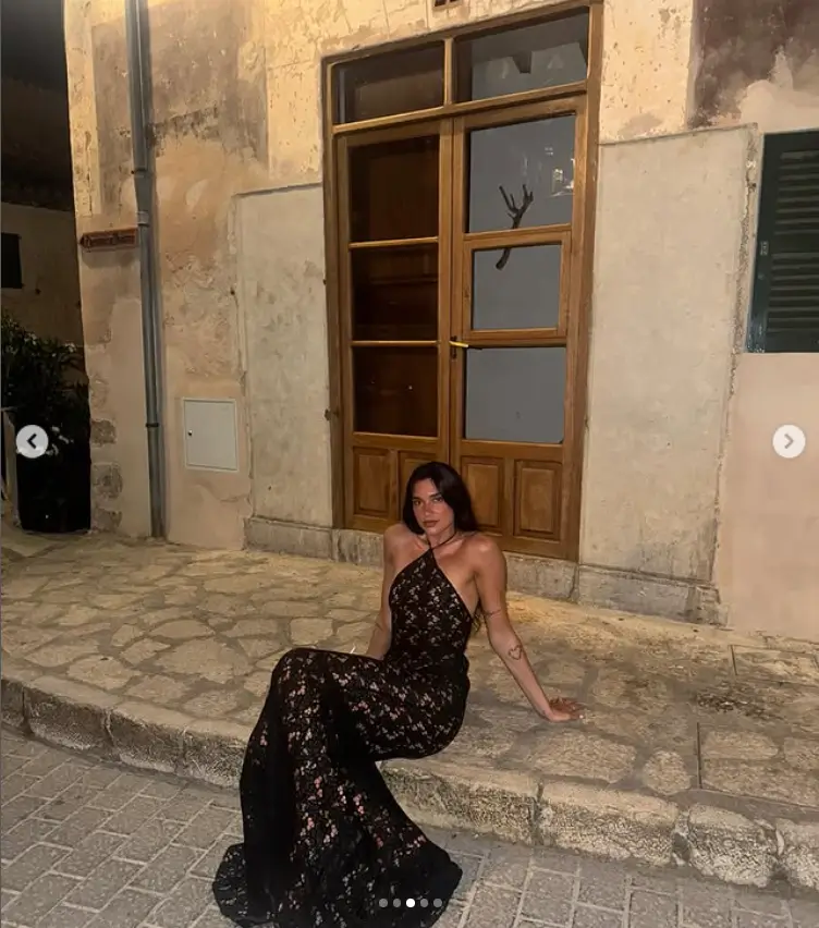 Within the collection, Dua Lipa made a striking impression in a black lace maxi dress. The garment accentuated her physique, showcasing her enviable figure.