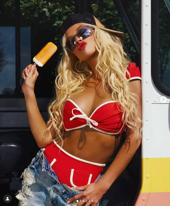 Adorned in a retro red bikini with white piping and adorable stitched-on accents, Christina exuded a radiant glow under the sun.