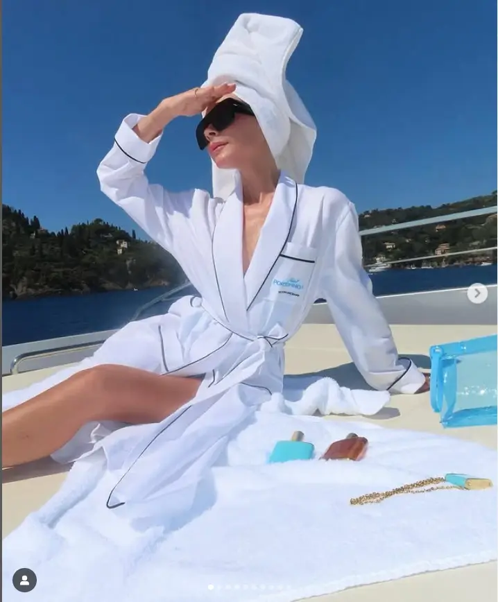 Victoria Beckham showed off her long legs in a soft white robe as she posed for pictures on her yacht in Portofino, Italy.