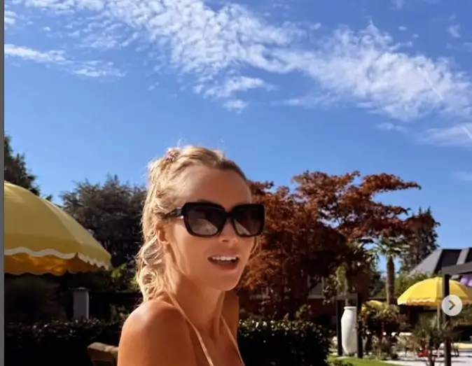 Amanda Holden shows off her curves while relaxing in her hot tub in a tiny bikini