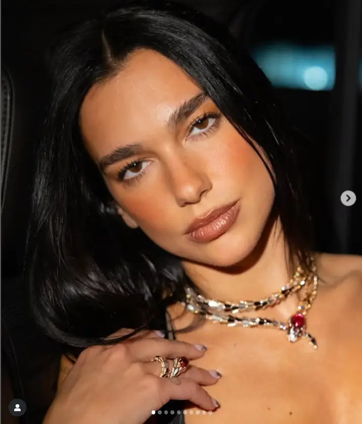 Dua Lipa looked glamorous in a low-cut tassel gown that showed off her toned body as she walked out of the glittering Harper's Bazaar Icons dinner in New York City.