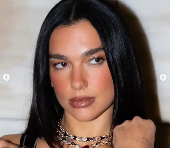 Dua Lipa dazzles in a stunning low-cut tasselled gown, she showcased her flawless physique and effortless glamour